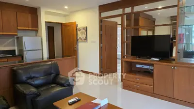 Spacious living room with modern furniture and open kitchen layout in a stylish apartment.