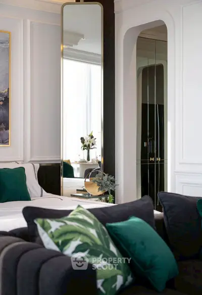 Luxurious living room with elegant decor and plush seating, featuring a large mirror and stylish accents.
