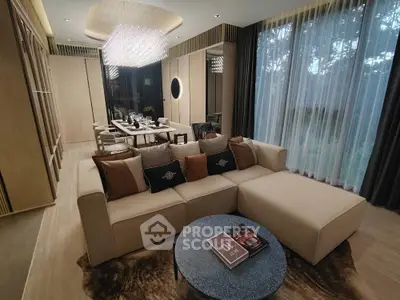 Luxurious living room with elegant dining area and modern chandelier