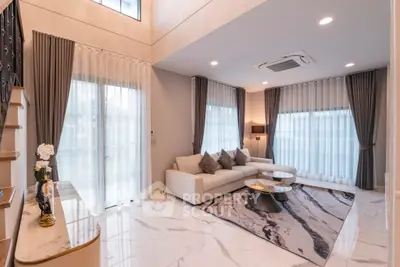 Luxurious modern living room with high ceilings and elegant decor