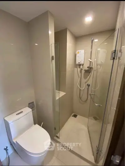 Modern bathroom with glass shower enclosure and sleek fixtures