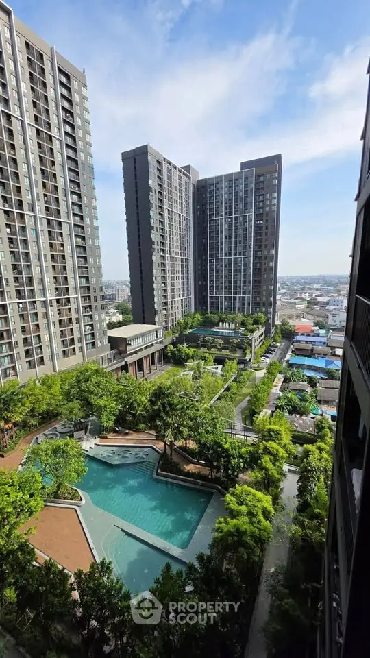Stunning high-rise apartment complex with lush gardens and inviting pool area.