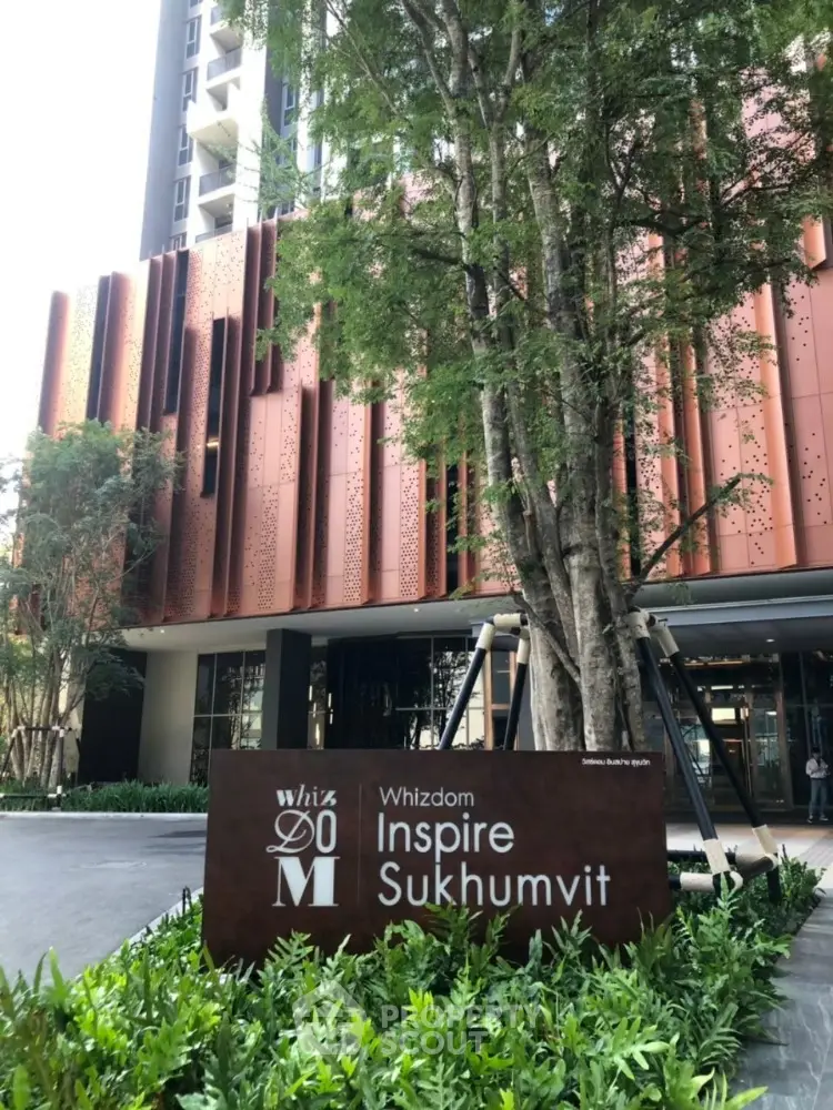 Modern building exterior with lush greenery at Whizdom Inspire Sukhumvit