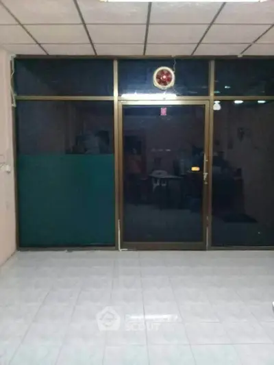 Spacious room with large glass doors and tiled flooring, ideal for versatile use.