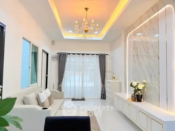 Elegant living room with chandelier and modern decor, featuring marble accent wall and ambient lighting.