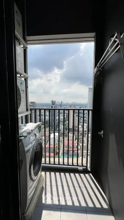 High-rise apartment balcony with washing machine and stunning city view.