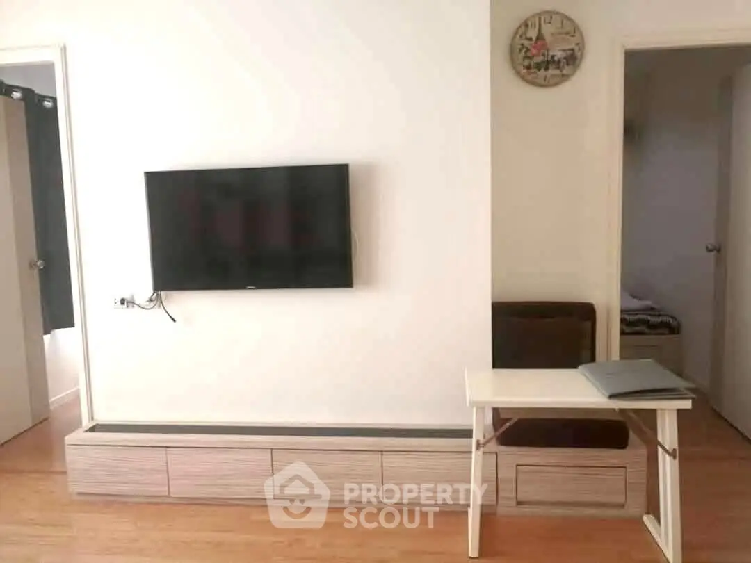 Modern living room with wall-mounted TV and minimalist decor