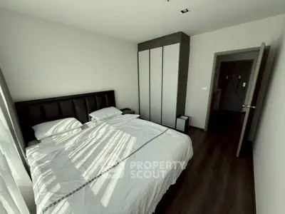Modern bedroom with sleek wardrobe and cozy bed in stylish apartment.
