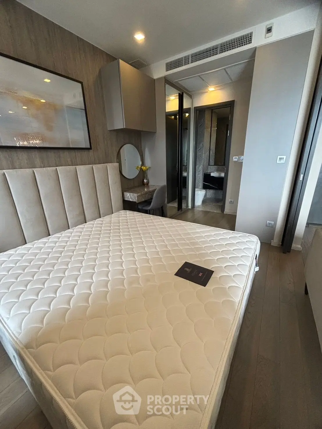 Modern bedroom with stylish decor and comfortable mattress in a luxury apartment.