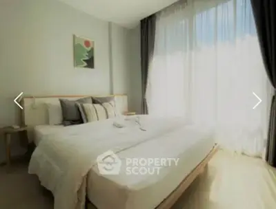 Bright and airy bedroom with large window and modern decor