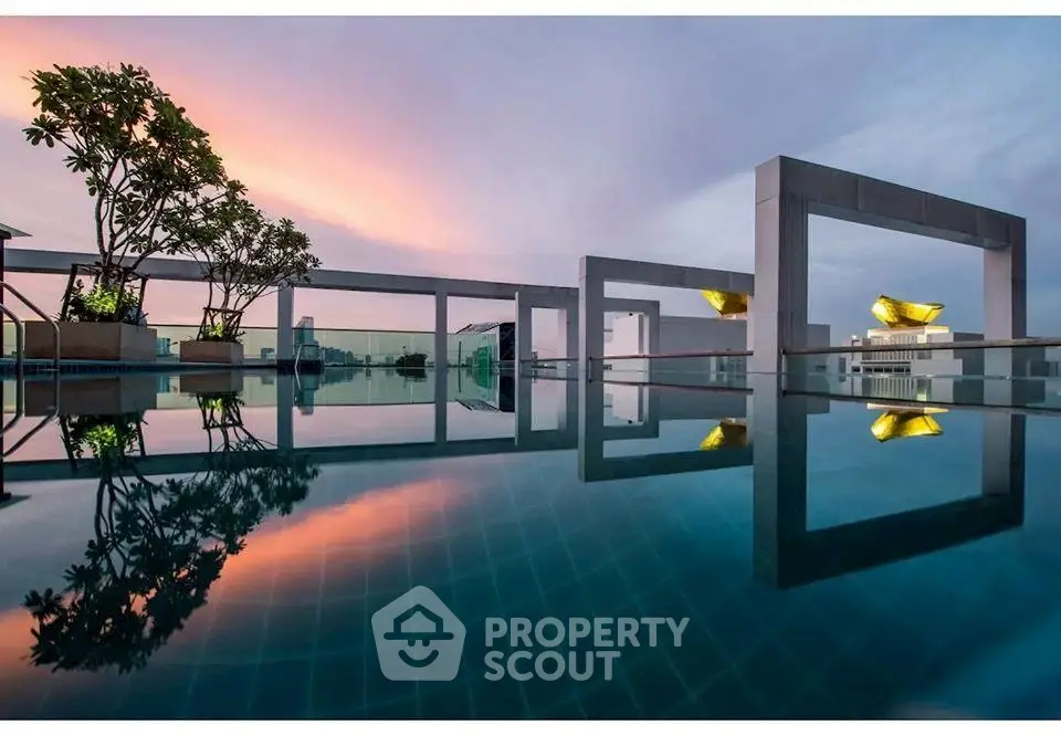 Stunning rooftop pool with modern architectural design and sunset view.