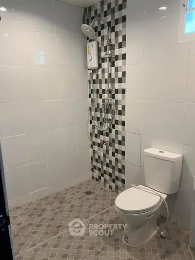 Modern bathroom with sleek tiles and shower unit
