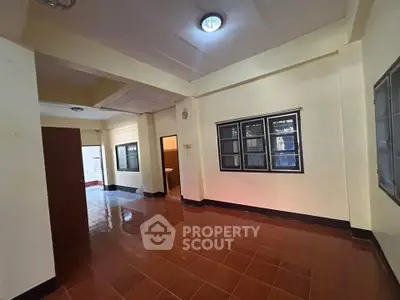 Spacious interior with tiled flooring and ample natural light, perfect for versatile living arrangements.