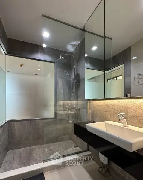 Modern bathroom with glass shower and sleek sink design