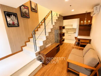 Modern duplex living room with stylish staircase and cozy seating area