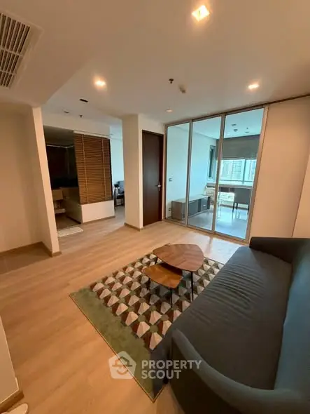Modern living room with stylish furniture and large windows in a contemporary apartment.