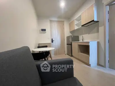 Modern compact living room with kitchenette in a cozy apartment