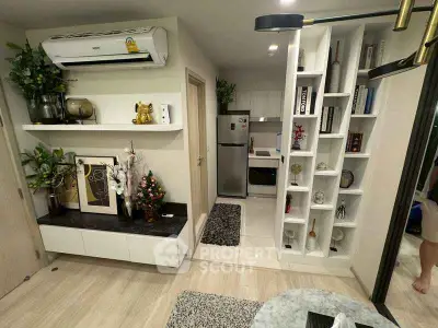 Modern living room with stylish decor and compact kitchen area