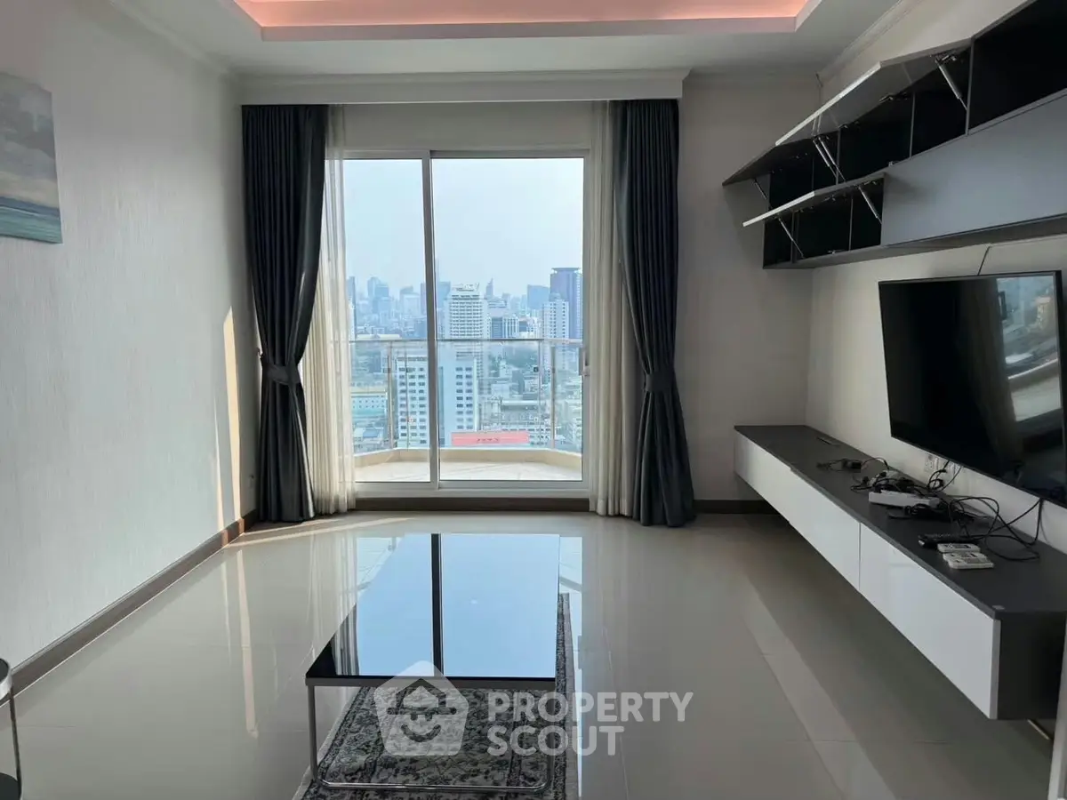 Modern living room with city view, sleek furniture, and large window for natural light.
