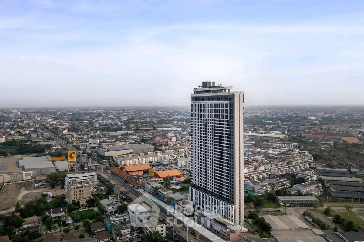 Stunning aerial view of a modern high-rise building in a bustling urban landscape.