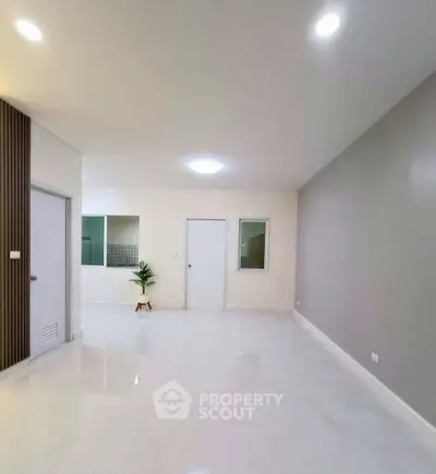 Spacious modern living room with sleek design and ample natural light.