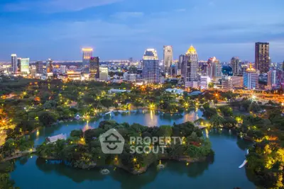 Stunning cityscape view with lush park and illuminated skyline at dusk, showcasing urban living harmony.