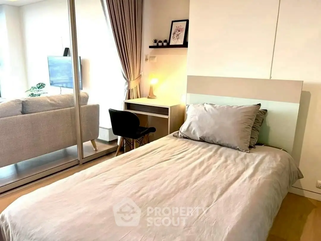 Modern bedroom with cozy bed and study desk in stylish apartment