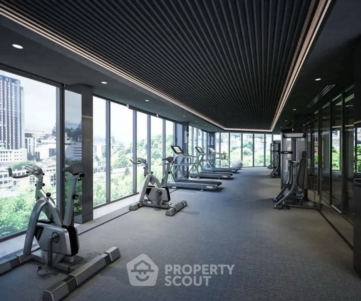 Modern gym with city view and state-of-the-art equipment in luxury high-rise building.