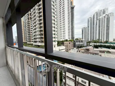 Stunning urban balcony view with modern high-rise buildings and cityscape.