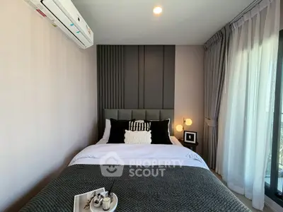 Modern bedroom with stylish decor and natural light, featuring a cozy bed and elegant curtains.