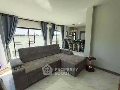 Spacious modern living room with large windows and elegant decor