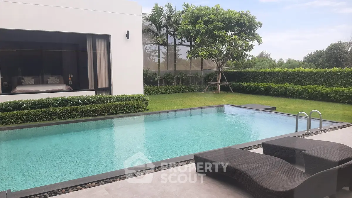 Luxurious modern home with private pool and lush garden view, perfect for relaxation and entertaining.