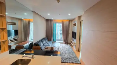 Modern living room with sleek design and large windows offering city views.