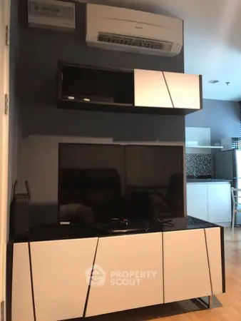 Modern living room with sleek TV unit and air conditioning