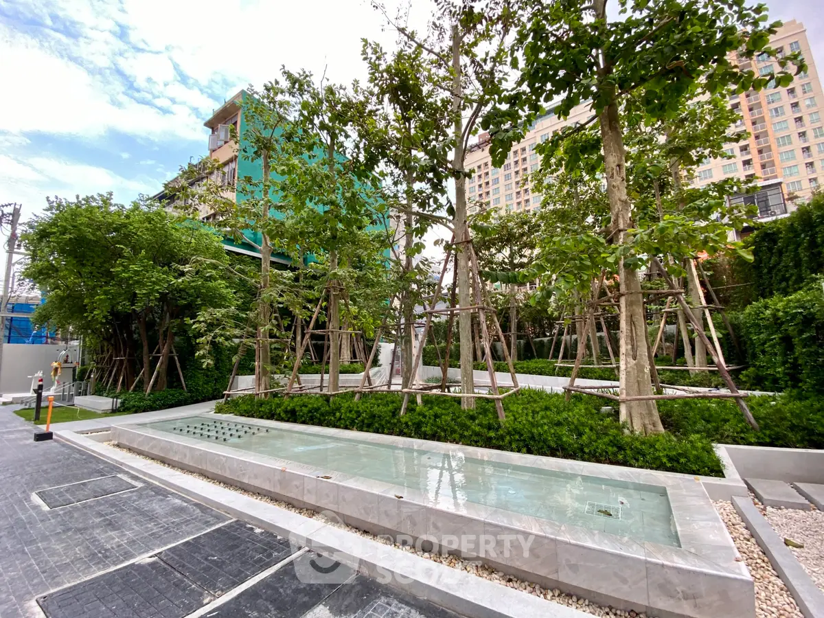 Luxurious garden area with modern water feature in upscale residential complex