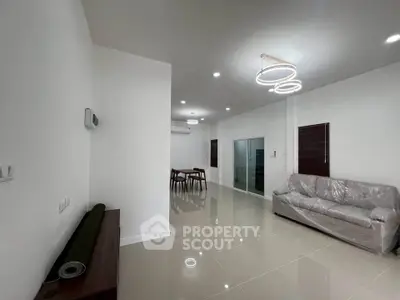 Spacious modern living room with sleek lighting and minimalist decor