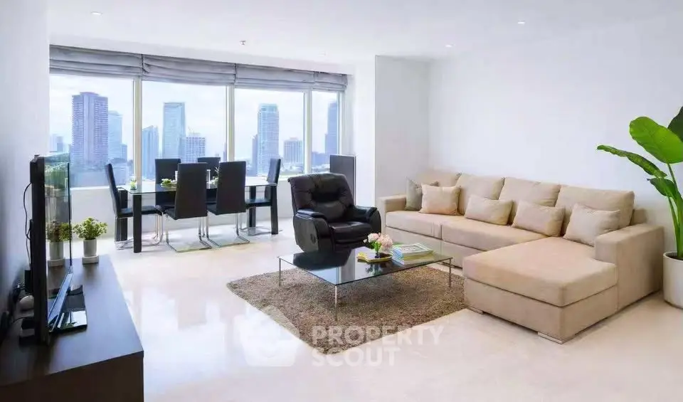 Spacious modern living room with city view, elegant furniture, and abundant natural light.