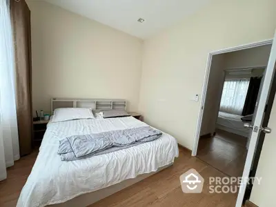 Cozy bedroom with wooden flooring and natural light