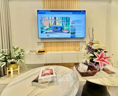 Modern living room with wall-mounted TV and elegant marble table