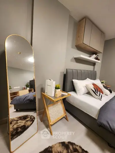 Stylish modern bedroom with elegant decor and full-length mirror
