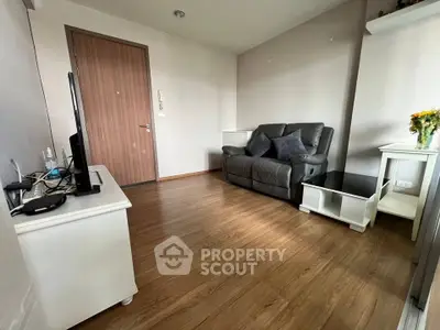 Cozy living room with wooden flooring and modern furniture in a stylish apartment.