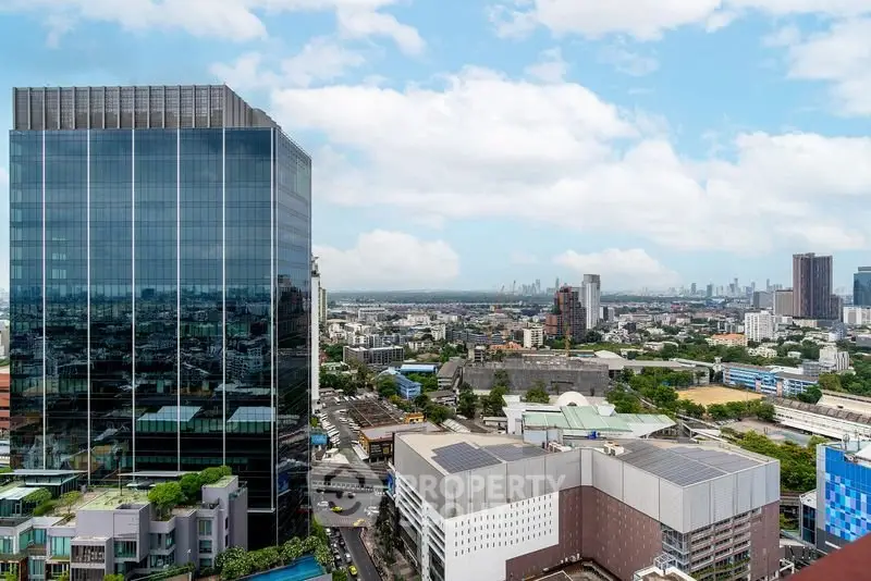 Stunning cityscape view with modern high-rise buildings and clear blue sky, perfect for urban living enthusiasts.