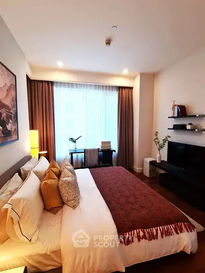 Luxurious bedroom with elegant decor and natural light, featuring a cozy bed and stylish furnishings.