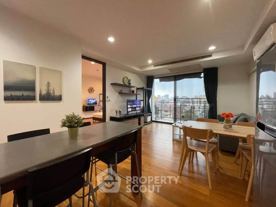 Spacious modern living room with city view, open layout, and stylish decor.
