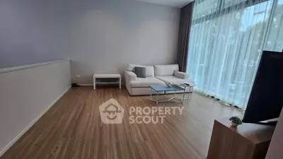 Spacious modern living room with large windows and elegant furnishings