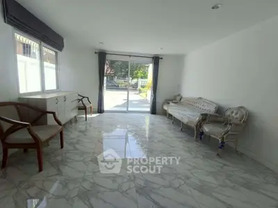 Spacious living room with elegant marble flooring and classic furniture