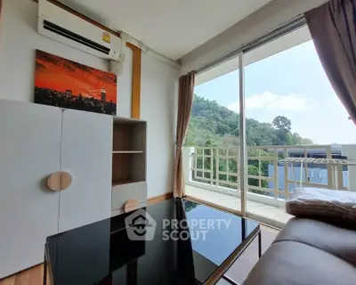 Modern living room with large windows and scenic balcony view