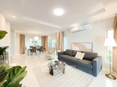 Spacious modern living room with elegant decor and open layout, perfect for family gatherings.
