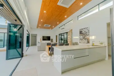 Luxurious open-plan living room with modern kitchen and high ceilings