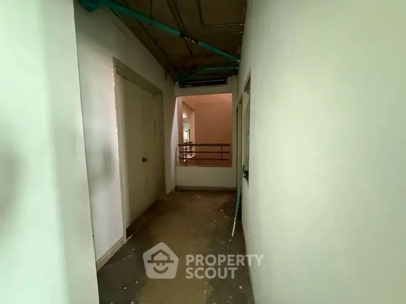Spacious corridor in a residential building under renovation, showcasing potential for modern design.